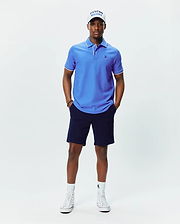 Mens Brad Pique Polo, vibrant blue classic fit pique polo with white tipping on collar and cuffs, featuring a small embroidered blue Psycho Bunny skull logo on the left chest.