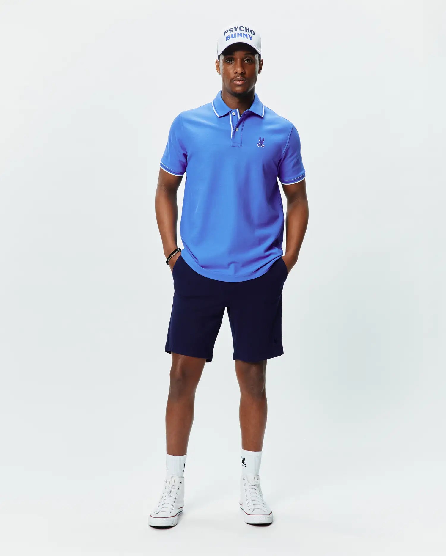 Mens Brad Pique Polo, vibrant blue classic fit pique polo with white tipping on collar and cuffs, featuring a small embroidered blue Psycho Bunny skull logo on the left chest.