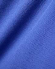 Close-up of the Mens Brad Pique Polo, featuring its vibrant royal blue color and classic textured pique knit fabric with soft, flowing folds.