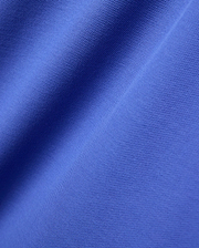 Close-up of the Mens Brad Pique Polo, featuring its vibrant royal blue color and classic textured pique knit fabric with soft, flowing folds.