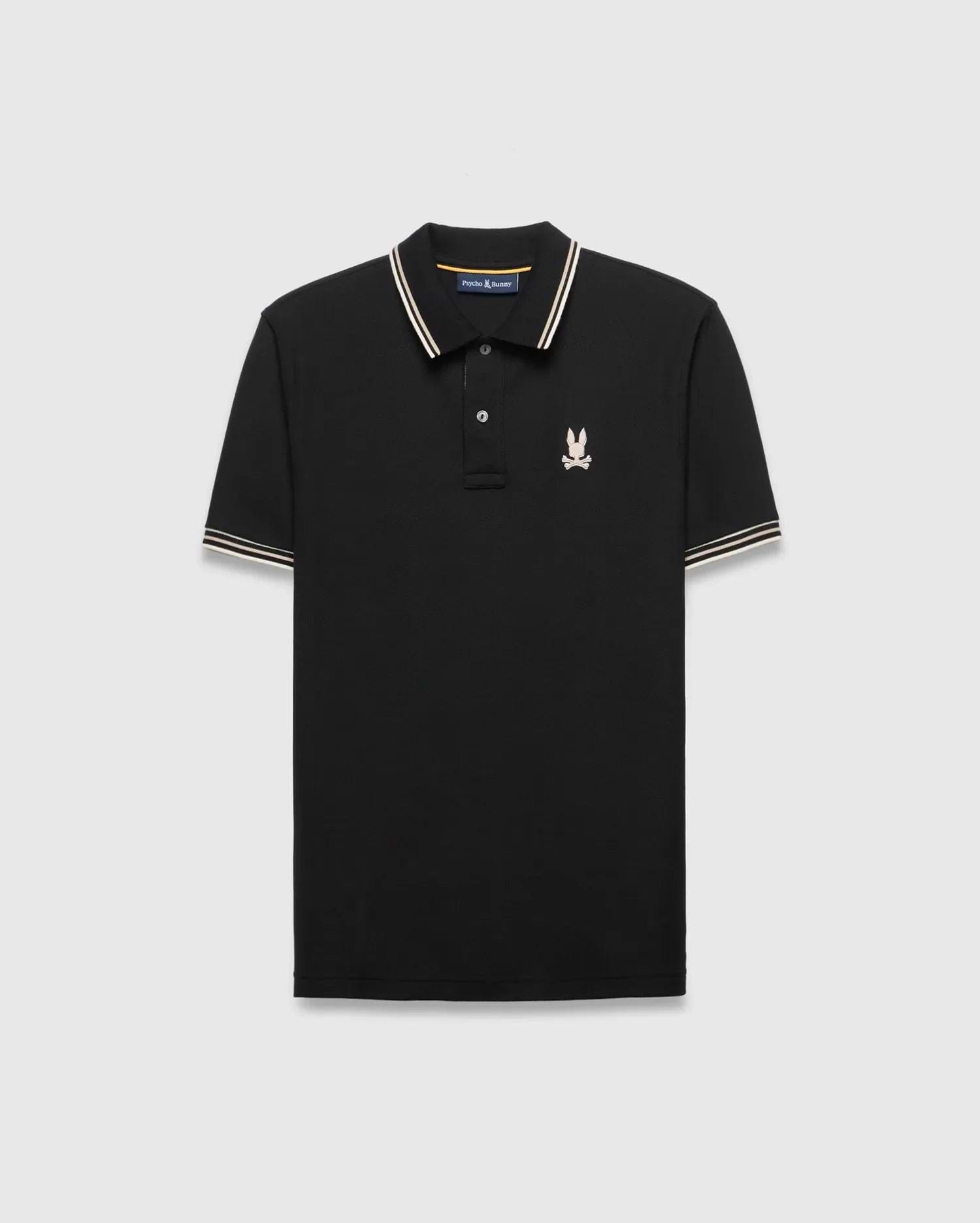 Mens Brad Pique Polo, black classic fit with white and gold striped collar and cuffs, featuring a small embroidered light pink/cream Psycho Bunny skull logo on the left chest. (5)