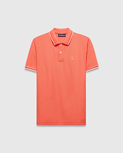 Vibrant Coral Mens Brad Pique Polo, a classic fit premium menswear piece with textured pique fabric, white and red tipped collar and cuffs, and a small embroidered Psycho Bunny skull logo on the left chest. (5)