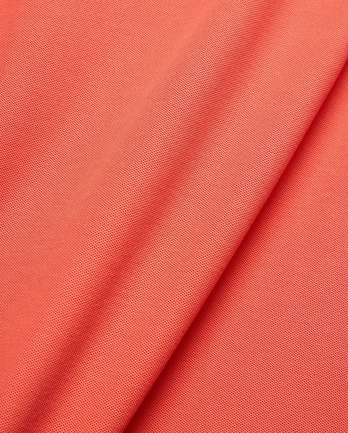 Mens Brad Pique Polo in vibrant coral, showcasing a refined pique knit texture. This premium Psycho Bunny polo features the iconic embroidered bunny skull logo on the chest. (6)