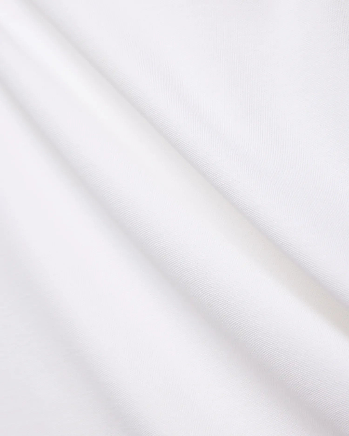 Crisp White Mens Brad Pique Polo fabric, highlighting its distinctive textured pique weave, soft, luxurious feel, and elegant folds, embodying premium Psycho Bunny menswear.