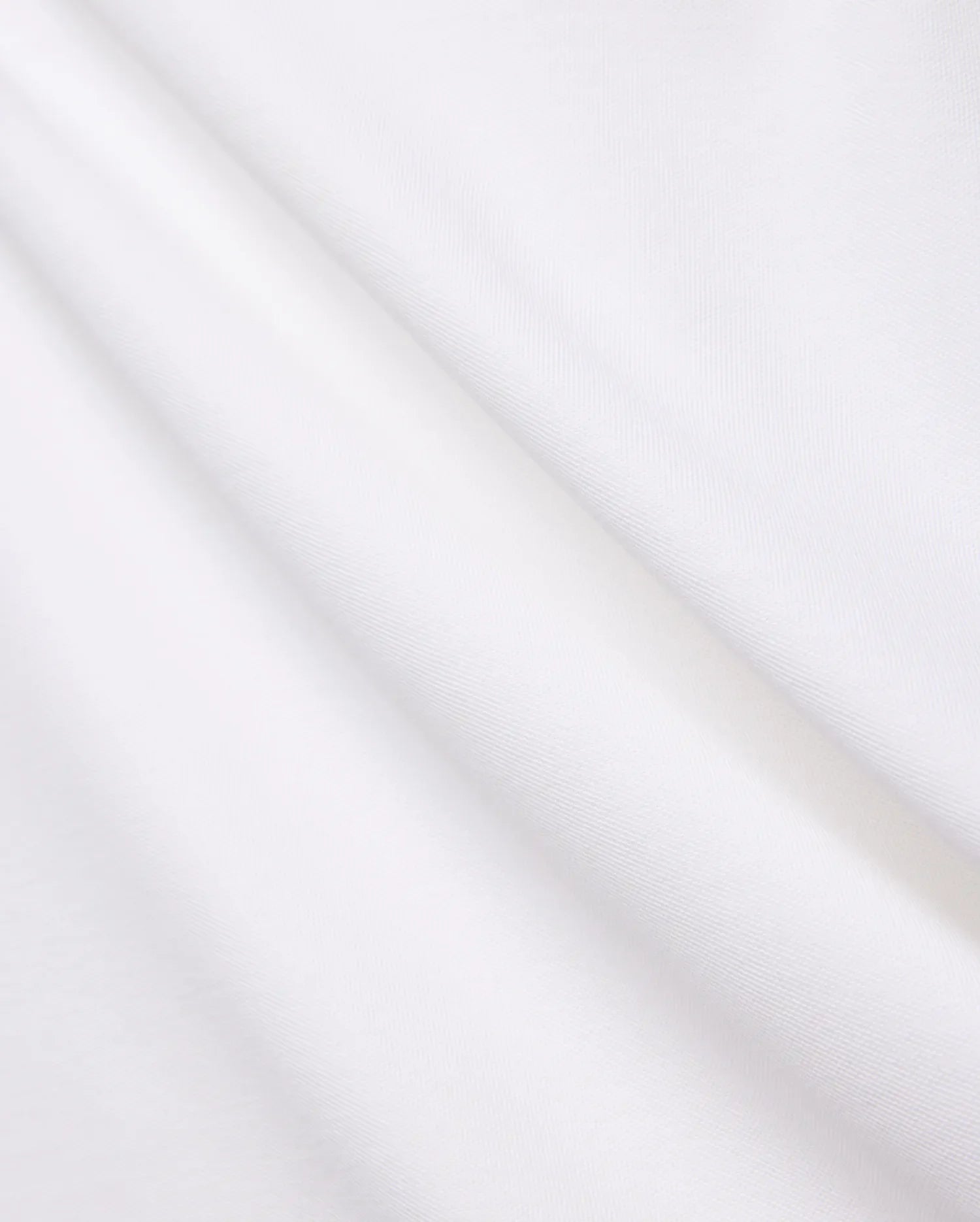 Crisp White Mens Brad Pique Polo fabric, highlighting its distinctive textured pique weave, soft, luxurious feel, and elegant folds, embodying premium Psycho Bunny menswear.