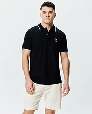 Mens Sunny Pique Polo, a classic fit black pique polo shirt with light blue and white striped collar and sleeve cuffs, featuring a small embroidered Psycho Bunny skull logo on the left chest. (1)