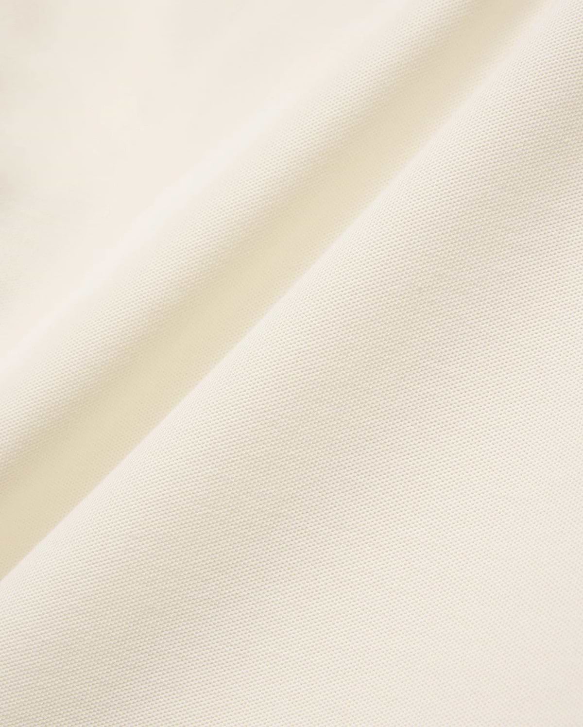 Mens Sunny Pique Polo in a rich cream hue, featuring a finely textured, breathable pique knit fabric, characteristic of Psycho Bunny's refined, comfortable menswear.