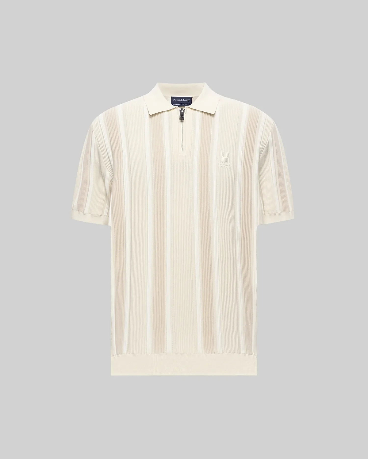 Mens Cliff Knit Zip Polo, a classic fit cream and beige vertical ribbed knit polo with quarter-zip, classic collar, short ribbed sleeves, ribbed hem, and small embroidered Psycho Bunny skull logo on left chest.