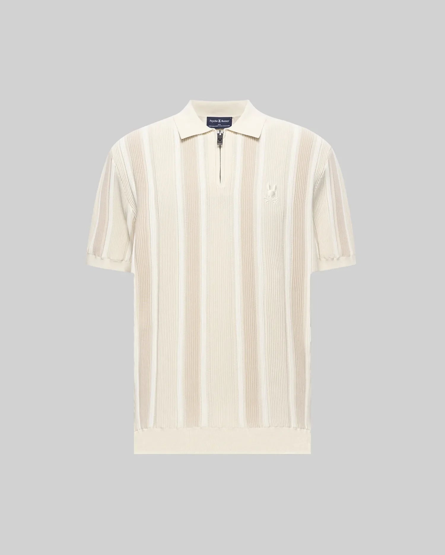 Mens Cliff Knit Zip Polo, a classic fit cream and beige vertical ribbed knit polo with quarter-zip, classic collar, short ribbed sleeves, ribbed hem, and small embroidered Psycho Bunny skull logo on left chest.