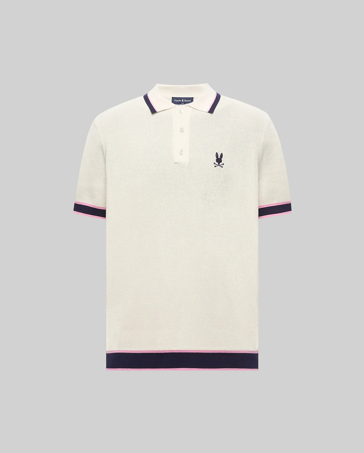 Cream textured knit Mens Dax Knit Polo with navy and pink striped collar, cuffs, and hem, featuring a small embroidered Psycho Bunny skull logo on the left chest. (5)