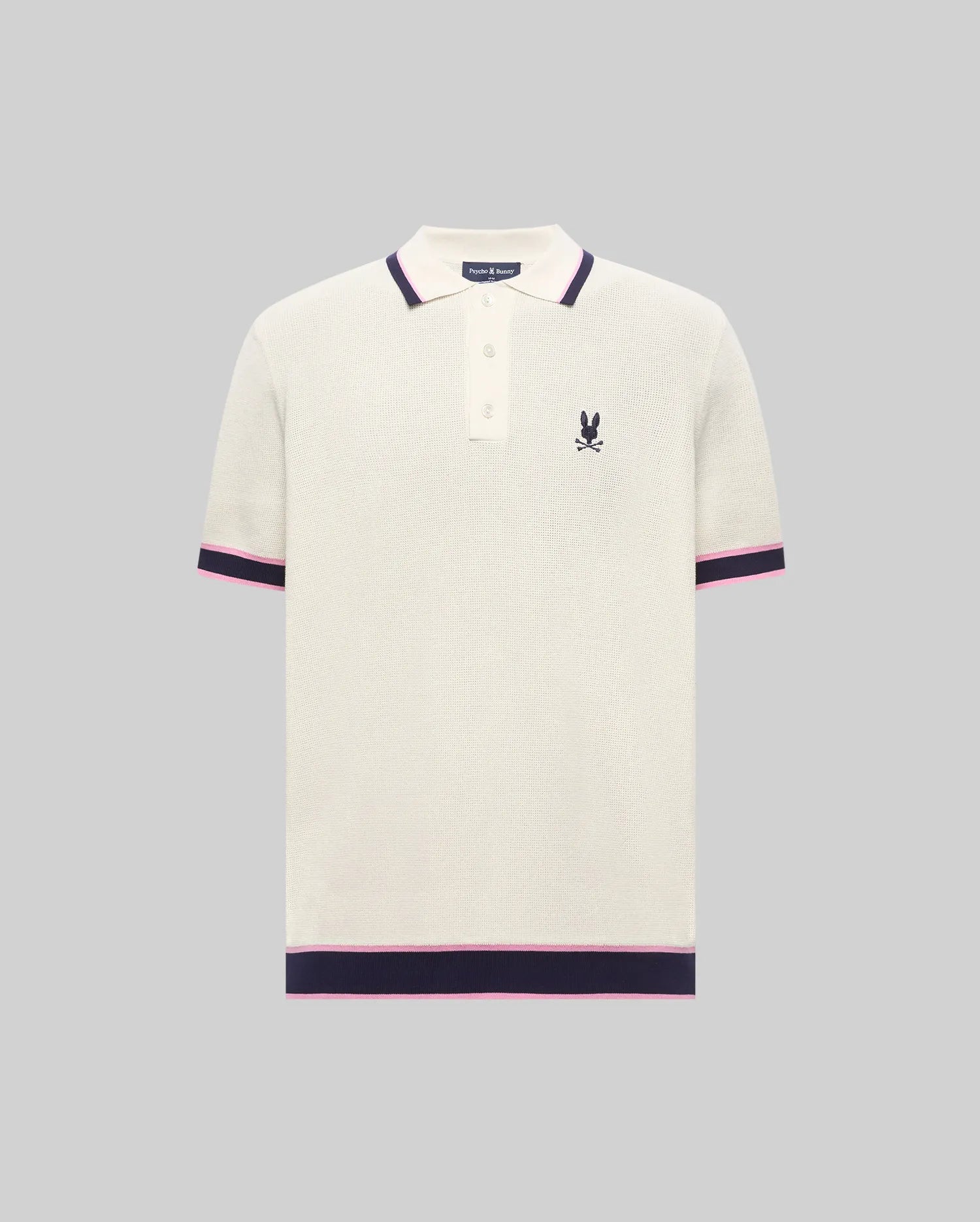 Cream textured knit Mens Dax Knit Polo with navy and pink striped collar, cuffs, and hem, featuring a small embroidered Psycho Bunny skull logo on the left chest. (5)