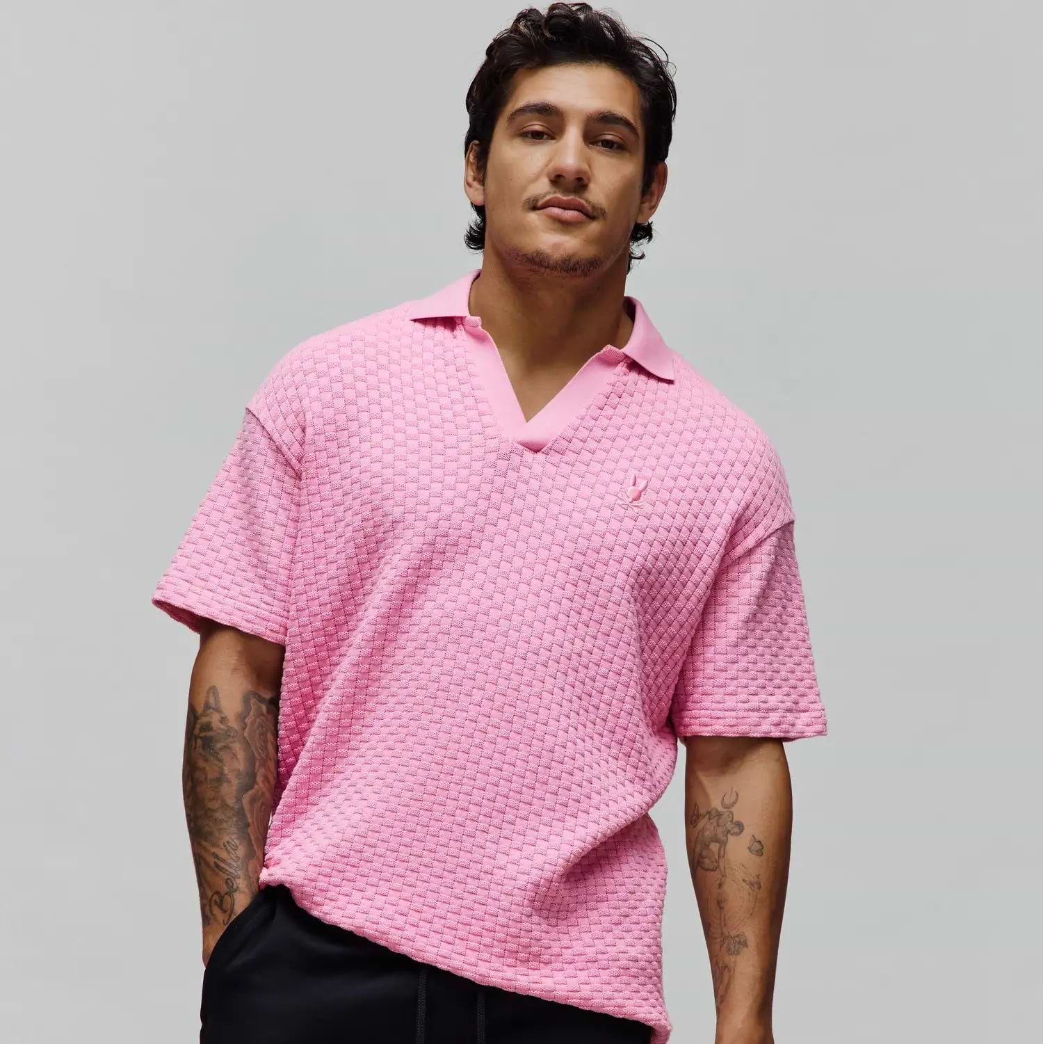 Mens Garen Knit Polo in vibrant pink, featuring a relaxed fit, distinctive basketweave knit texture, and a small embroidered Psycho Bunny skull logo on the left chest. (4)