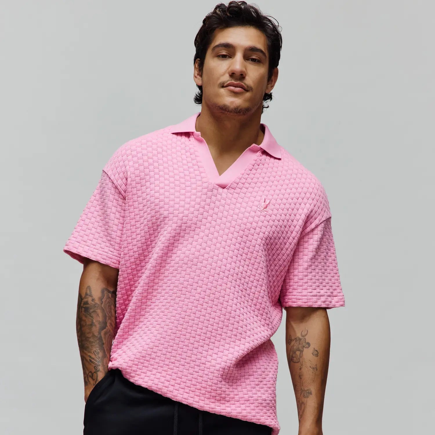 Mens Garen Knit Polo in vibrant pink, featuring a relaxed fit, distinctive basketweave knit texture, and a small embroidered Psycho Bunny skull logo on the left chest. (4)