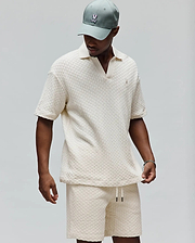 Mens Garen Knit Polo in cream, featuring a relaxed fit, textured basketweave knit fabric, an open resort collar, and a small embroidered Psycho Bunny skull logo on the left chest. (3)
