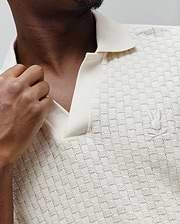 Mens Garen Knit Polo in cream, featuring a textured basketweave knit pattern, an open collar, and a small embroidered Psycho Bunny skull logo on the left chest. (2)
