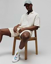 Mens Garen Knit Polo in cream, featuring a relaxed fit and a distinctive textured basketweave knit fabric, with a small, tone-on-tone embroidered Psycho Bunny skull logo on the left chest. (1)