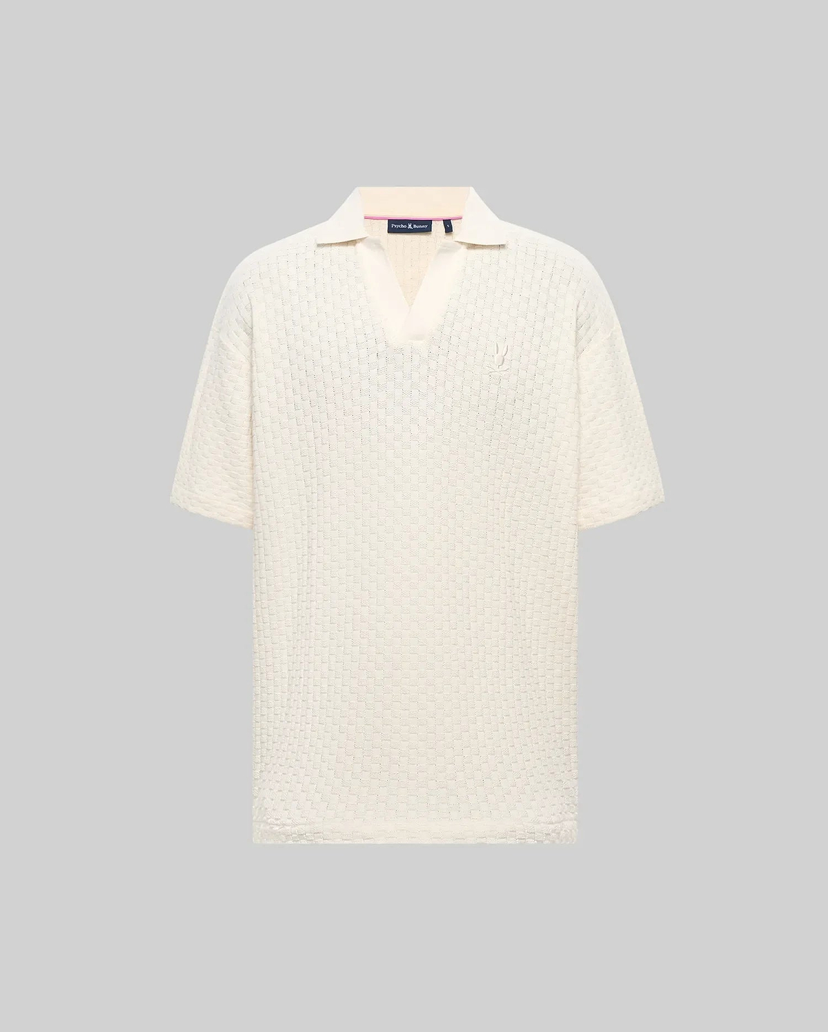 Mens Garen Knit Polo in cream, featuring a relaxed fit, textured knit fabric with a subtle grid pattern, spread collar, and a small, tonal embroidered Psycho Bunny skull on the left chest. (4)