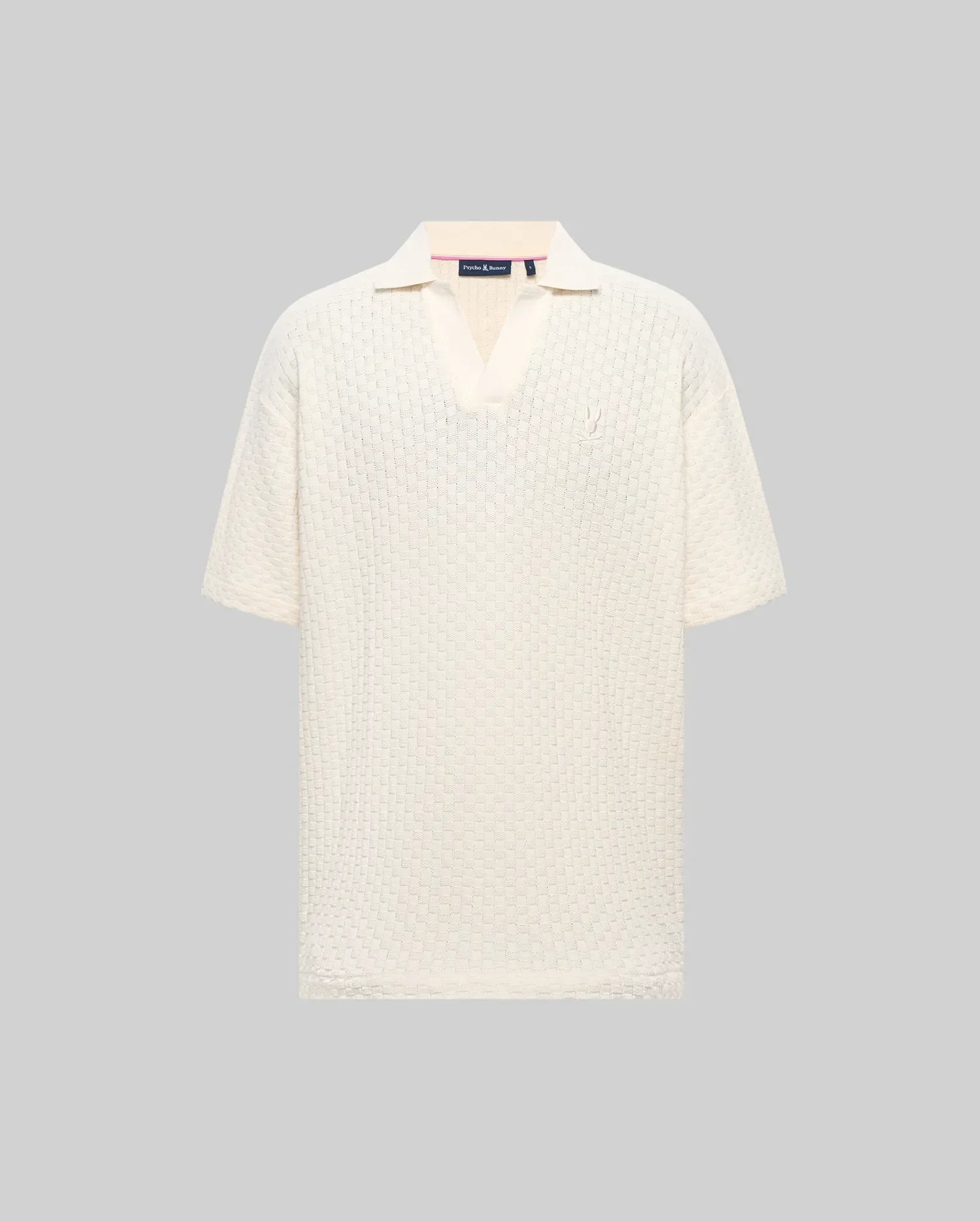 Mens Garen Knit Polo in cream, featuring a relaxed fit, textured knit fabric with a subtle grid pattern, spread collar, and a small, tonal embroidered Psycho Bunny skull on the left chest. (4)
