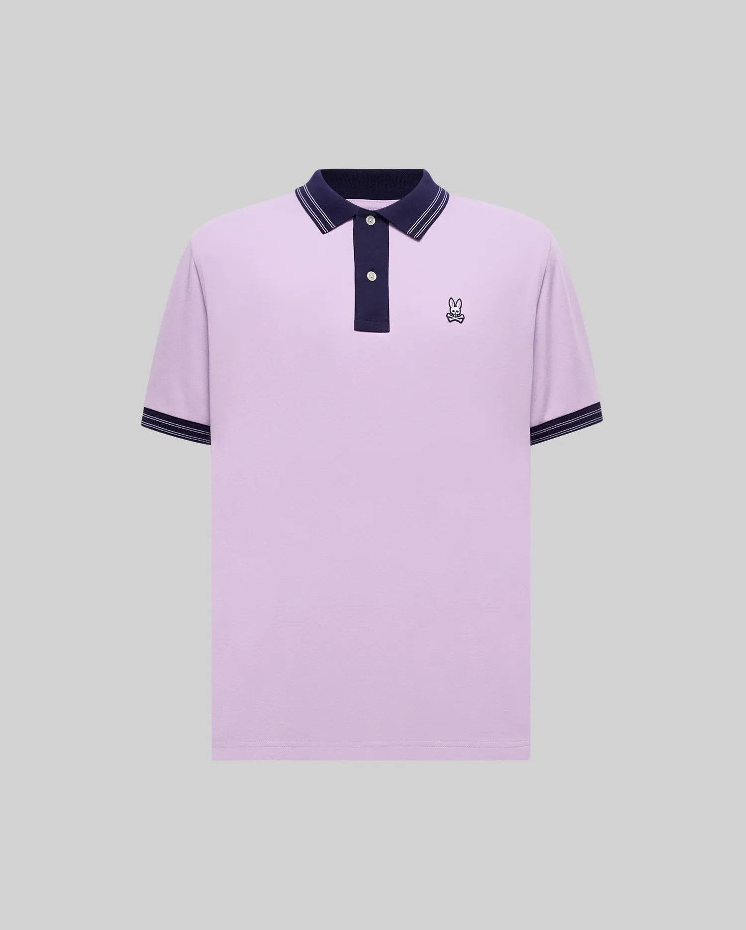 Mens Kenyon Pique Polo, a lavender classic fit pique polo with navy collar, two-button placket, navy cuffs with white stripes, and a small embroidered Psycho Bunny skull logo on the left chest.
