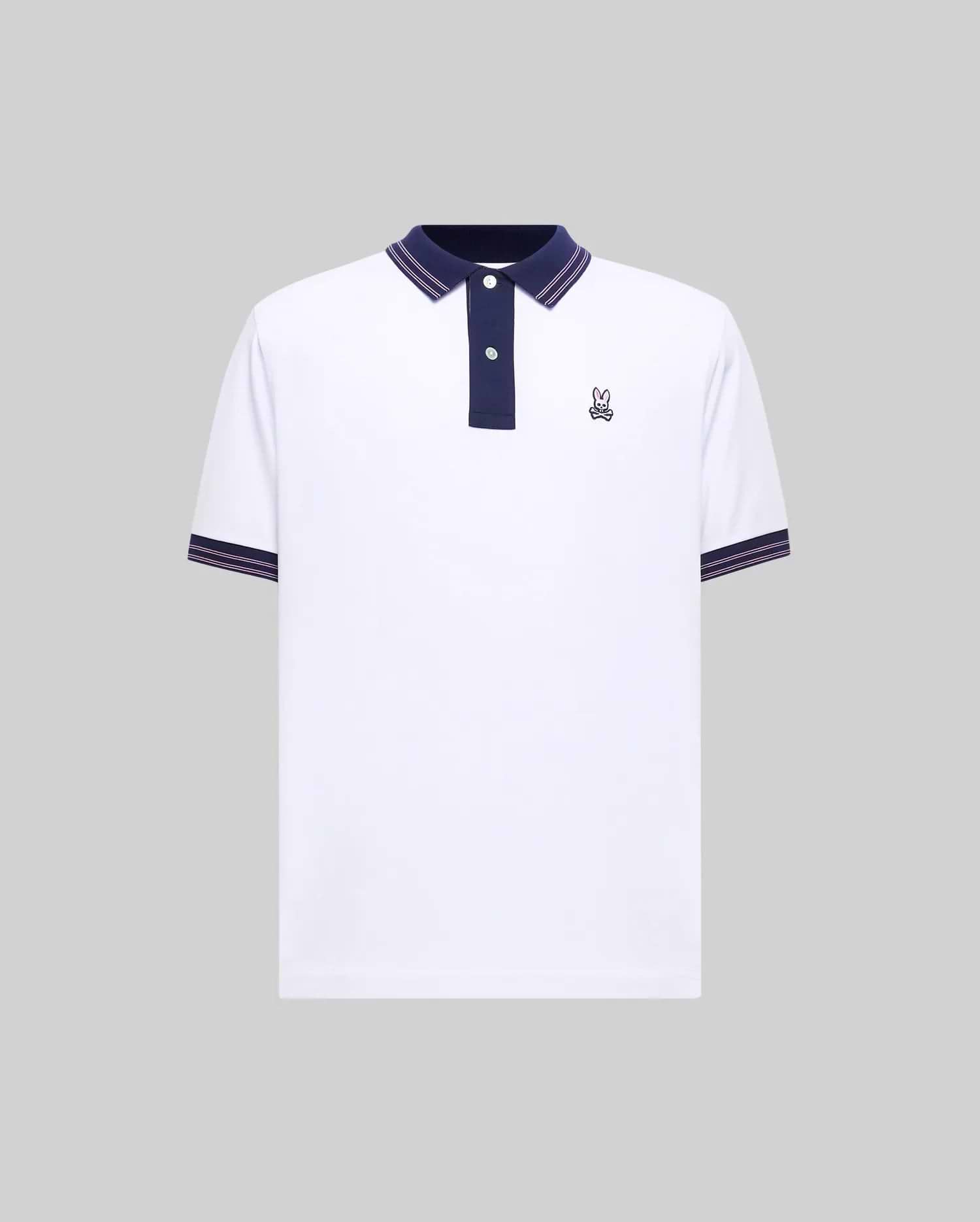 Mens Kenyon Pique Polo, a white classic fit pique polo with navy collar, two-button placket, and red/white striped trim on collar and cuffs, featuring a small embroidered Psycho Bunny skull logo on the left chest.