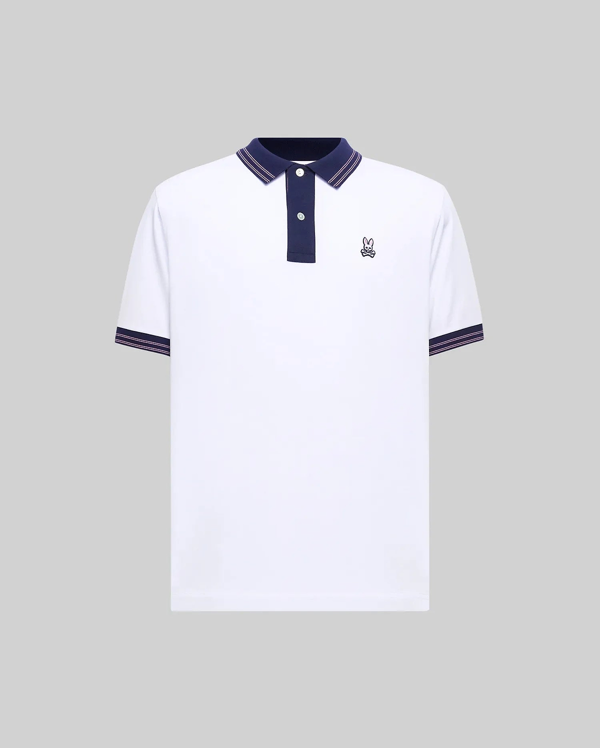 Mens Kenyon Pique Polo, a white classic fit pique polo with navy collar, two-button placket, and red/white striped trim on collar and cuffs, featuring a small embroidered Psycho Bunny skull logo on the left chest.