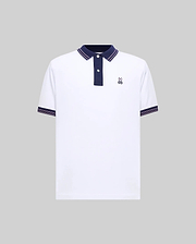 Mens Kenyon Pique Polo, a white classic fit pique polo with navy collar, two-button placket, and red/white striped trim on collar and cuffs, featuring a small embroidered Psycho Bunny skull logo on the left chest.