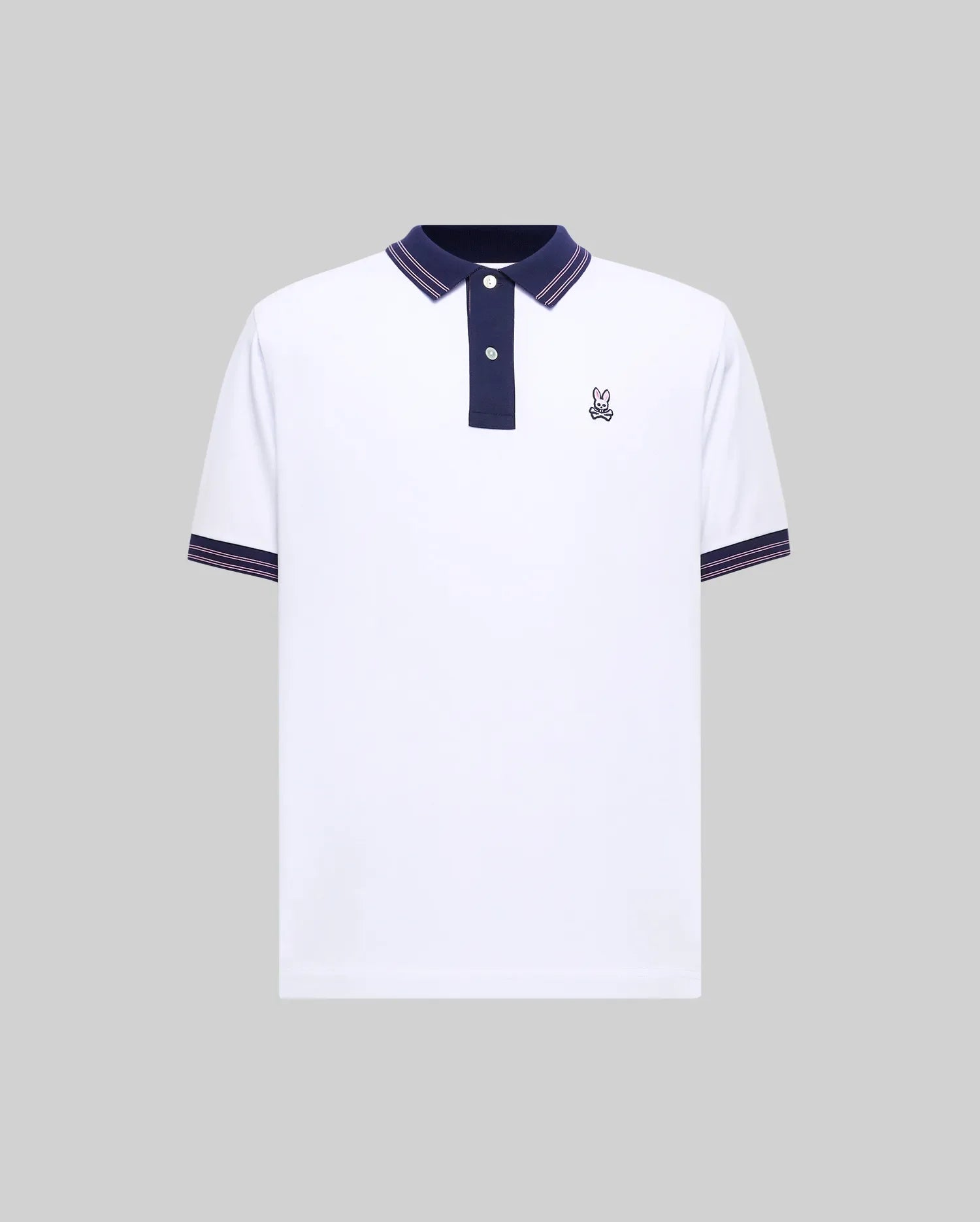 Mens Kenyon Pique Polo, a white classic fit pique polo with navy collar, two-button placket, and red/white striped trim on collar and cuffs, featuring a small embroidered Psycho Bunny skull logo on the left chest.