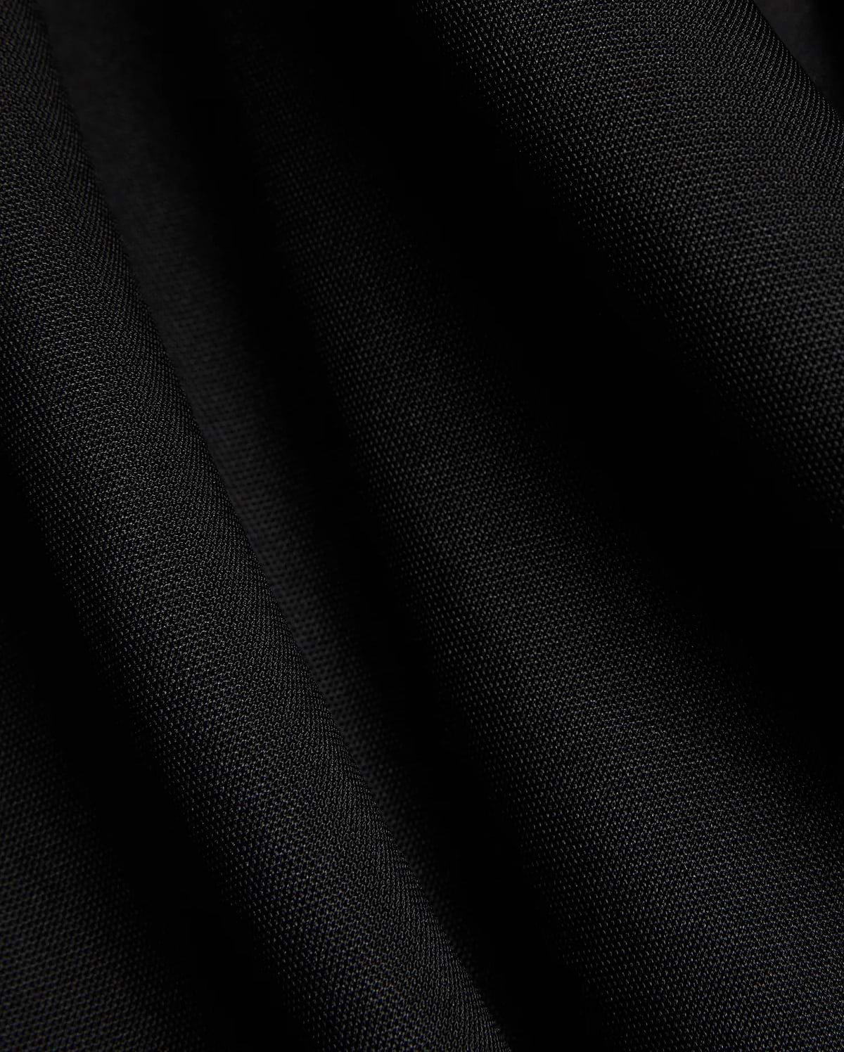 Mens Odin Zip Sport Polo in a rich black, featuring a visible premium pique knit fabric texture, characteristic of Psycho Bunny's refined streetwear style.