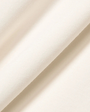 Premium cream Mens Timmy Interlock Polo fabric, featuring a refined, smooth, and dense knit texture, embodying Psycho Bunny's signature bold yet sophisticated streetwear aesthetic.