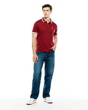 Mens Timmy Interlock Polo, a classic fit maroon interlock knit polo with white tipped collar and cuffs, featuring a small embroidered Psycho Bunny skull logo on the left chest.