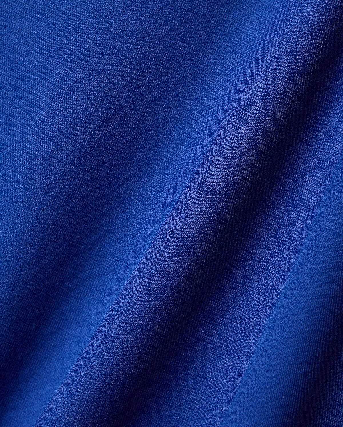 Mens Timmy Interlock Polo in a rich, vibrant royal blue, crafted from premium, soft interlock knit fabric, showcasing its refined texture and elegant drape, perfect for sophisticated streetwear.
