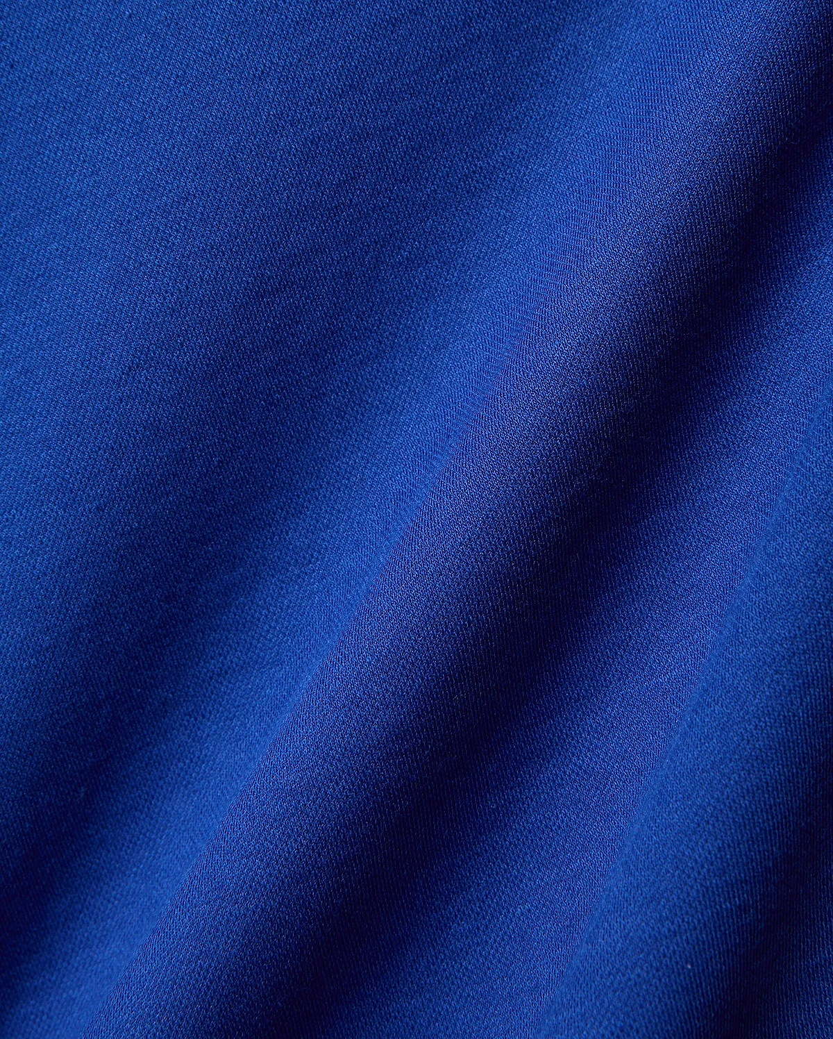 Mens Timmy Interlock Polo in a rich, vibrant royal blue, crafted from premium, soft interlock knit fabric, showcasing its refined texture and elegant drape, perfect for sophisticated streetwear.