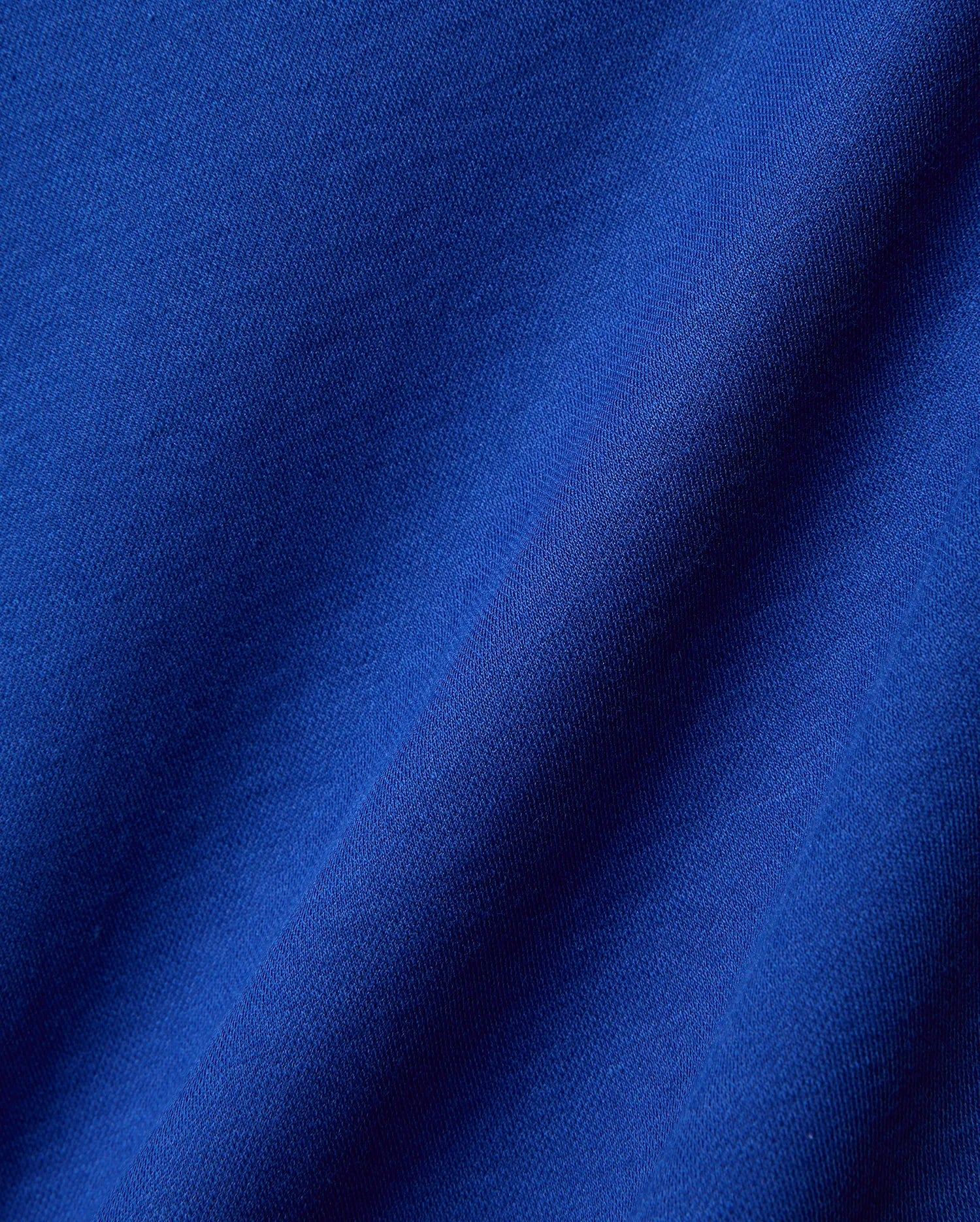 Mens Timmy Interlock Polo in a rich, vibrant royal blue, crafted from premium, soft interlock knit fabric, showcasing its refined texture and elegant drape, perfect for sophisticated streetwear.