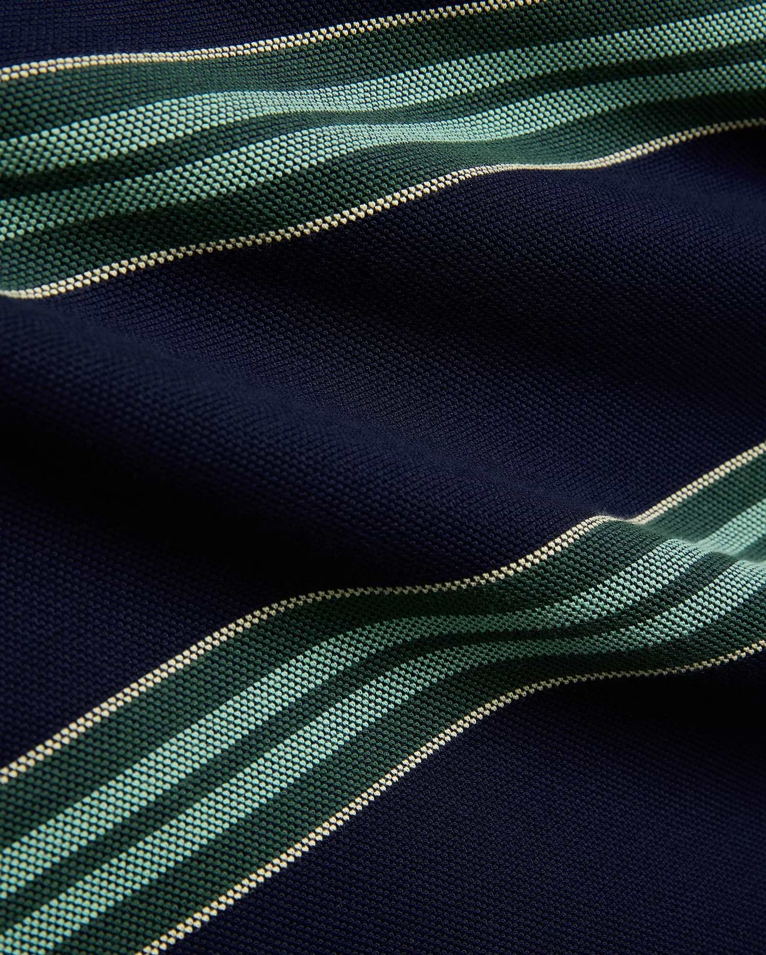 Mens Drew Striped Pique Polo in navy blue, featuring bold horizontal stripes in dark green, light green, and cream, showcasing its textured pique fabric.