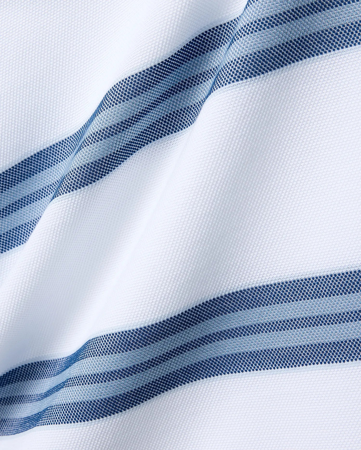 Mens Drew Striped Pique Polo featuring a crisp white pique fabric base, accented with bold horizontal stripes in varying shades of navy blue and light blue, each stripe intricately textured with a fine dotted pattern. (5)