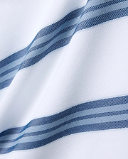 Mens Drew Striped Pique Polo featuring a crisp white pique fabric base, accented with bold horizontal stripes in varying shades of navy blue and light blue, each stripe intricately textured with a fine dotted pattern. (5)
