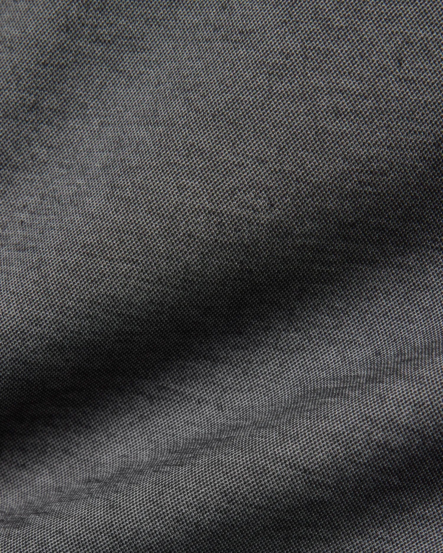Psycho Bunny MENS JOJI PERFORMANCE POLO in a deep charcoal grey, featuring a premium, subtly textured pique knit fabric, offering a refined streetwear aesthetic and classic fit.