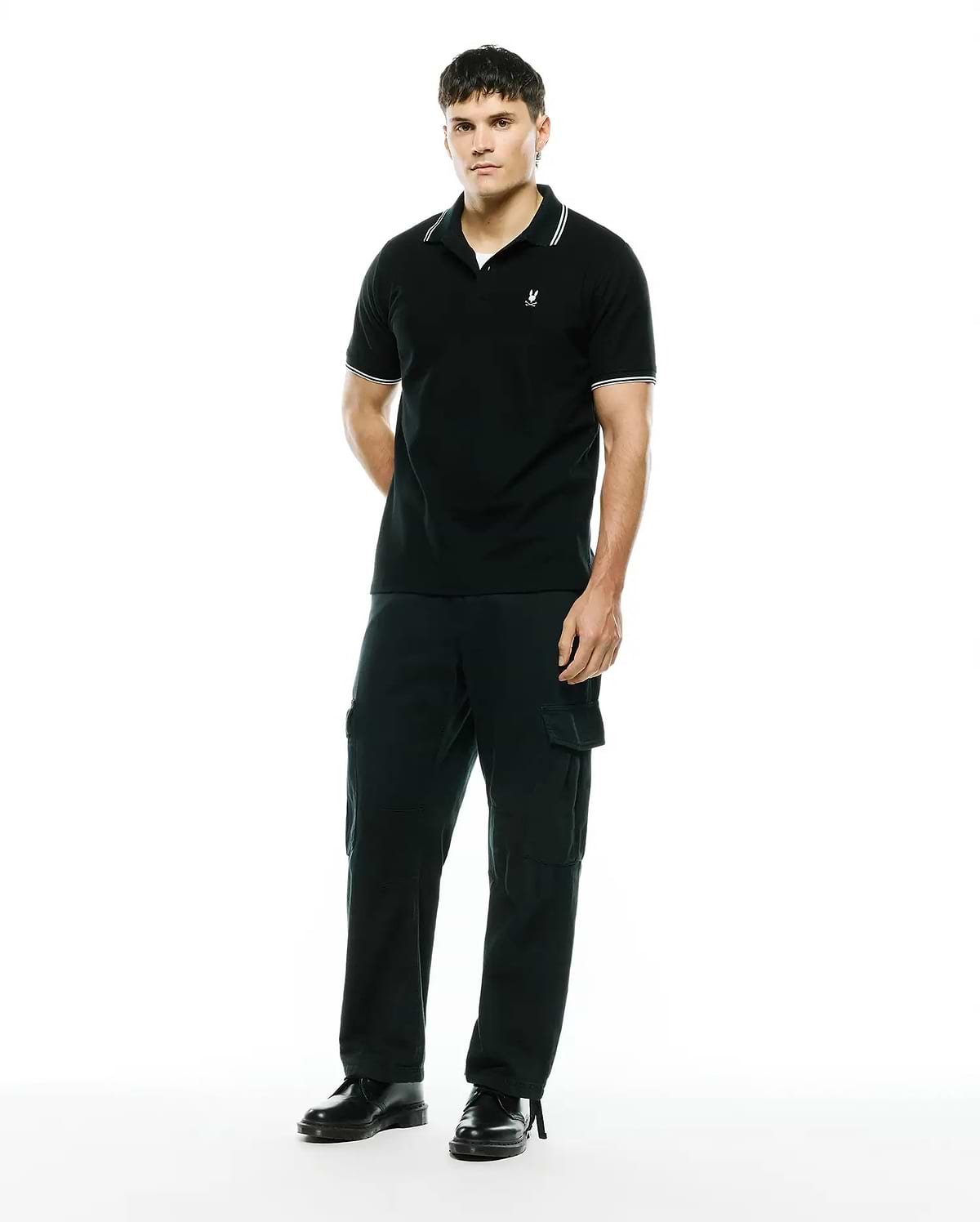 Mens Stan Pique Polo, black with white tipped collar and cuffs, featuring a small embroidered Psycho Bunny skull logo on the left chest in a classic pique knit. (3)