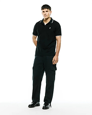 Mens Stan Pique Polo, black with white tipped collar and cuffs, featuring a small embroidered Psycho Bunny skull logo on the left chest in a classic pique knit. (3)