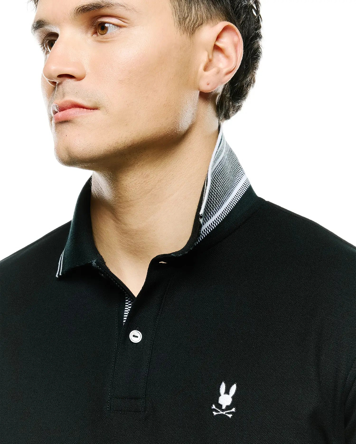 Mens Stan Pique Polo, black classic-fit pique polo with white embroidered Psycho Bunny skull logo on chest, white buttons, and a black and white striped inner collar. (2)