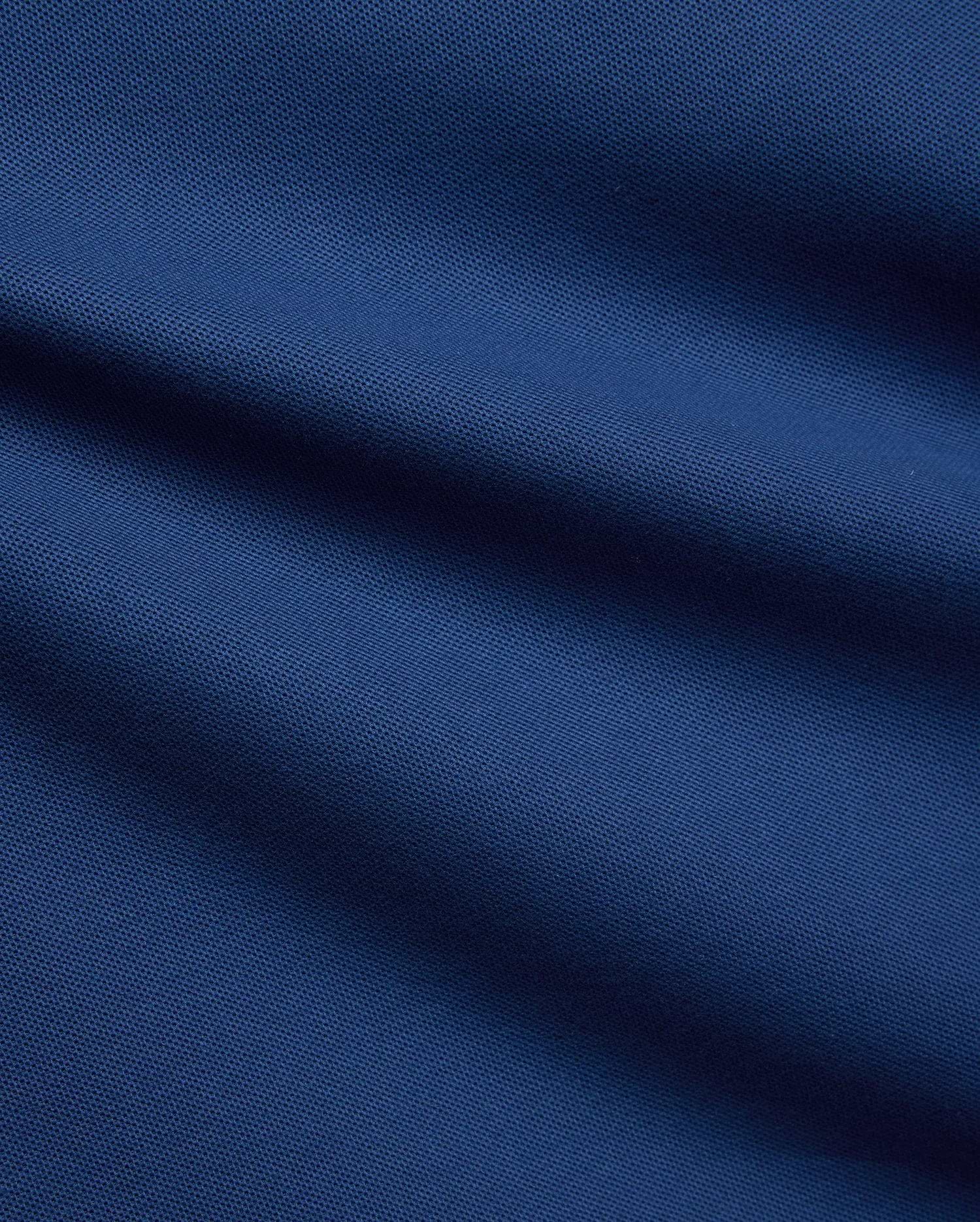 Mens Stan Pique Polo in a rich, deep blue, highlighting the classic textured pique weave, a premium and breathable fabric from Psycho Bunny menswear. (6)