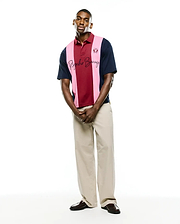 Mens Chad Relaxed Fit Striped Polo in navy, burgundy, and pink pique knit, featuring a small embroidered bunny skull on the left chest and a large script Psycho Bunny logo across the chest.