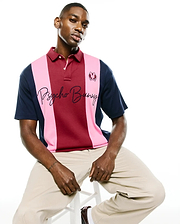 Mens Chad Relaxed Fit Striped Polo in navy, pink, and burgundy pique knit, featuring a small embroidered bunny skull logo on the right chest and a large embroidered Psycho Bunny script across the front.