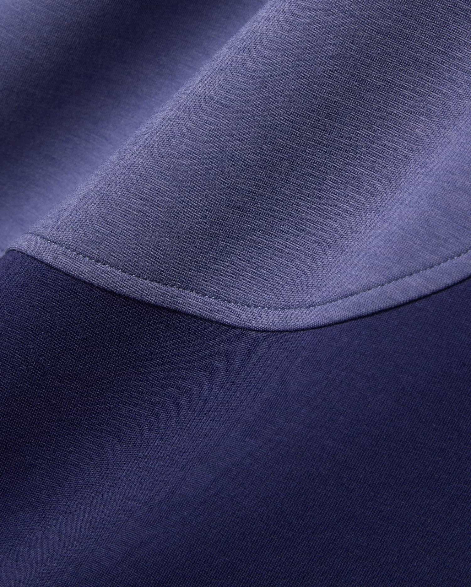 Mens Kelly Oversized Polo in dark navy and periwinkle blue color-block pique knit fabric, featuring a curved seam with visible stitching. (6)