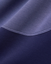 Mens Kelly Oversized Polo in dark navy and periwinkle blue color-block pique knit fabric, featuring a curved seam with visible stitching. (6)