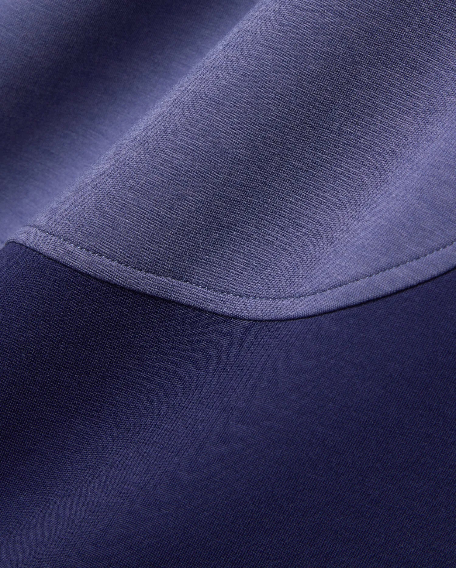 Mens Kelly Oversized Polo in dark navy and periwinkle blue color-block pique knit fabric, featuring a curved seam with visible stitching. (6)