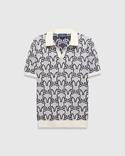 Mens Sidney Oversized Knit Polo, a cream and navy blue jacquard knit polo featuring an all-over Psycho Bunny skull logo pattern, solid cream collar, cuffs, and an oversized fit. (4)
