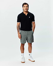 Black MENS SELBY KNIT POLO, classic fit, with an open collar, fine knit texture, white double-striped sleeve cuffs, and a small embroidered white Psycho Bunny skull logo on the left chest. (3)