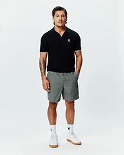 Black MENS SELBY KNIT POLO, classic fit, with an open collar, fine knit texture, white double-striped sleeve cuffs, and a small embroidered white Psycho Bunny skull logo on the left chest. (3)