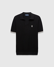 Black Mens Selby Knit Polo featuring a textured knit, classic fit, v-neck collar, and ribbed cuffs with white and cream double stripes. A small white embroidered Psycho Bunny skull logo adorns the left chest. (4)